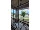 View from inside of front porch featuring rocking chairs and stone-clad support column at 22345 E Bailey Pl, Aurora, CO 80016