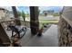 Inviting front porch with rocking chairs, stone pillars, and a view of the landscaped yard at 22345 E Bailey Pl, Aurora, CO 80016