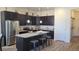 Modern kitchen featuring granite countertops, stainless steel appliances, and dark cabinetry at 22345 E Bailey Pl, Aurora, CO 80016