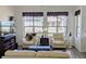 Bright living room featuring comfortable seating, large windows, and stylish decor at 22345 E Bailey Pl, Aurora, CO 80016