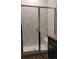 Close-up of the glass-enclosed shower with a built-in seat and modern tile at 22345 E Bailey Pl, Aurora, CO 80016