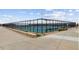 Well-maintained tennis court surrounded by black fencing, offering an enclosed playing area at 22345 E Bailey Pl, Aurora, CO 80016