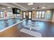 Bright yoga studio with wood floors, mirrored wall, and a ceiling fan at 22345 E Bailey Pl, Aurora, CO 80016