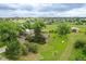 Charming home nestled on a vast, green lot with mature trees and detached garage at 12798 Tomahawk Rd, Parker, CO 80138