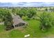 Aerial view of a home nestled on a large lot with green grass and mature trees at 12798 Tomahawk Rd, Parker, CO 80138