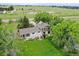 Aerial view of country home with mature trees, large lot, and back deck at 12798 Tomahawk Rd, Parker, CO 80138