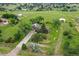 An aerial view of the home on sprawling green acreage with outbuildings and trees at 12798 Tomahawk Rd, Parker, CO 80138