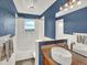 Bathroom featuring blue walls, a modern sink and a window with scenic views at 12798 Tomahawk Rd, Parker, CO 80138