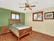 Cozy bedroom featuring hardwood floors, wooden-framed windows and bed, complemented by soft, neutral decor and ample natural light at 12798 Tomahawk Rd, Parker, CO 80138