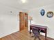 Bedroom showcasing hardwood floors, desk, chair, and wood doors at 12798 Tomahawk Rd, Parker, CO 80138