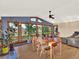 Sunlit dining area with hardwood floors, a ceiling fan, and expansive windows at 12798 Tomahawk Rd, Parker, CO 80138