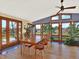 Bright dining room with large windows, hardwood floors, and seating for four at 12798 Tomahawk Rd, Parker, CO 80138