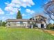 Rear view of the home exhibiting a deck, siding, and expansive yard under a bright sky with fluffy clouds at 12798 Tomahawk Rd, Parker, CO 80138