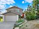 Charming exterior with front door, nicely landscaped yard, and an attached garage at 12798 Tomahawk Rd, Parker, CO 80138