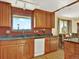 Well-lit kitchen features wood cabinets, granite countertops, stainless appliances and a view from the window over the sink at 12798 Tomahawk Rd, Parker, CO 80138