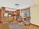 Inviting kitchen area with warm wood cabinets, hardwood floors, and window with natural light at 12798 Tomahawk Rd, Parker, CO 80138