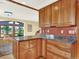 Kitchen area showcasing custom wood cabinets, granite countertops, and an open layout to a dining and living space at 12798 Tomahawk Rd, Parker, CO 80138