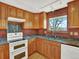 Well-equipped kitchen with wood cabinets, granite countertops, and modern appliances for a delightful cooking experience at 12798 Tomahawk Rd, Parker, CO 80138