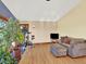 Comfortable living space with hardwood floors, a sofa, an exercise bike and large windows at 12798 Tomahawk Rd, Parker, CO 80138