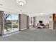 Spacious living room with sliding glass door, carpet and neutral paint at 12798 Tomahawk Rd, Parker, CO 80138