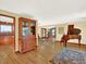 Open-concept living room with hardwood floors, large hutch, and a view into the dining room, ideal for entertaining at 12798 Tomahawk Rd, Parker, CO 80138