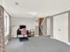 Living room featuring light gray walls, neutral carpeting, and a staircase at 12798 Tomahawk Rd, Parker, CO 80138