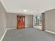 Living room features light gray walls, neutral carpeting, and a sliding glass door at 12798 Tomahawk Rd, Parker, CO 80138