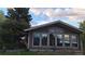 Living room with large windows reflecting trees, clouds, and sky on a sunny day at 12798 Tomahawk Rd, Parker, CO 80138