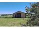 Large outbuilding with roll-up door offers secure storage for equipment and supplies at 12798 Tomahawk Rd, Parker, CO 80138