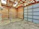 Interior of outbuilding with wood paneling, sliding roll up door, and skylights at 12798 Tomahawk Rd, Parker, CO 80138