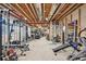 Unfinished basement area with exposed ceiling, framing, and a complete home gym at 27423 E Euclid Dr, Aurora, CO 80016