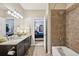 This bathroom features a tiled shower and granite countertops, with access to the bedroom at 27423 E Euclid Dr, Aurora, CO 80016