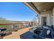 Upper level deck featuring wood flooring, patio furniture, and views of the neighborhood at 27423 E Euclid Dr, Aurora, CO 80016