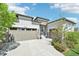Home exterior featuring well-manicured landscaping, a spacious driveway, and two-car garage at 27423 E Euclid Dr, Aurora, CO 80016