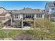 Back exterior view of a two story home with a patio and upper deck at 27423 E Euclid Dr, Aurora, CO 80016