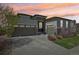 Charming home with a three-car garage, stone accents, and well-maintained landscaping, set against a colorful sky at 27423 E Euclid Dr, Aurora, CO 80016