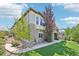 Well-maintained home exterior featuring a lush lawn and stone accents with a three car garage at 27423 E Euclid Dr, Aurora, CO 80016