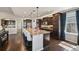 Well-equipped kitchen with an island, dark cabinets, stainless steel appliances, and hardwood floors at 27423 E Euclid Dr, Aurora, CO 80016