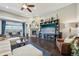 Open living room with a fireplace, large windows, and stylish decor at 27423 E Euclid Dr, Aurora, CO 80016