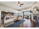 Open-concept living space with hardwood floors, modern fireplace, and a glimpse into the gourmet kitchen and dining area at 27423 E Euclid Dr, Aurora, CO 80016