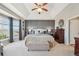 This main bedroom features a tray ceiling, a gray accent wall, and a sitting bench at 27423 E Euclid Dr, Aurora, CO 80016