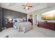 An expansive main bedroom features stylish decor, and a large TV on the wall at 27423 E Euclid Dr, Aurora, CO 80016