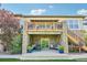 Exterior stone patio with comfortable seating and stairs leading to the upper deck at 27423 E Euclid Dr, Aurora, CO 80016