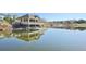 A pond house overlooks the lake in this aerial, offering a relaxing escape with nature's beauty and serene waters at 27423 E Euclid Dr, Aurora, CO 80016