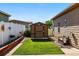 Well-maintained backyard with green lawn, storage shed, and white picket fence at 6231 Indian Paintbrush St # 214, Frederick, CO 80530