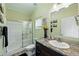 Clean bathroom with a shower stall with glass door, granite countertop, and sunflower decorations at 6231 Indian Paintbrush St # 214, Frederick, CO 80530