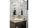 Updated bathroom vanity with a marble-look countertop, decorative accents, and towel hook at 6231 Indian Paintbrush St # 214, Frederick, CO 80530