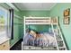 Cozy bedroom with a white bunk bed, wall shelving, and colorful bedding at 6231 Indian Paintbrush St # 214, Frederick, CO 80530
