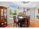Bright dining space with large windows, wood table, and matching chairs, perfect for entertaining at 6231 Indian Paintbrush St # 214, Frederick, CO 80530