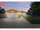 Charming single-story home featuring a well-maintained lawn, a two-car garage, and inviting curb appeal at 6231 Indian Paintbrush St # 214, Frederick, CO 80530